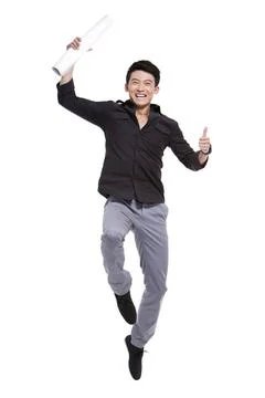 Excited Chinese man with blueprint jumping Beijing China Copyright: xLanex... Stock Photos
