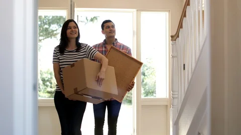 Excited Couple Carrying Boxes Into New Home On Moving Day Shot In Slow Motion Stock Footage