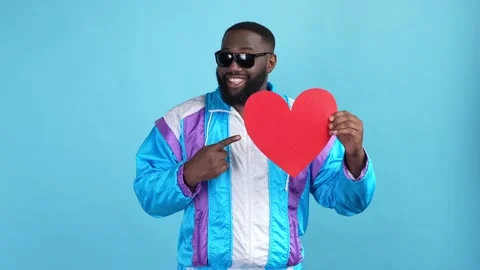 Excited crazy guy point card heart fist up isolated blue color background Stock Footage 167549408