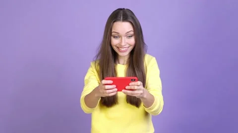 Excited crazy lady play device fist up isolated vivid color background Stock Footage 169998265