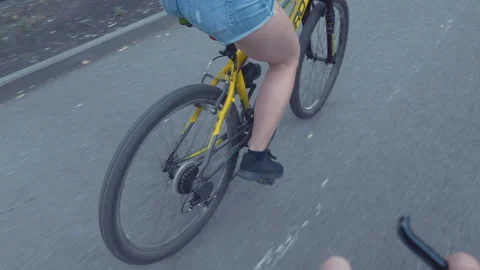 An excited dad helps her young Asian daughter ride her pink bike without Stock Footage 91960183