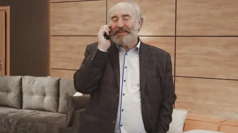 Excited elderly senior chatting sharing news on mobile phone with grown up child Stock Footage 148952080