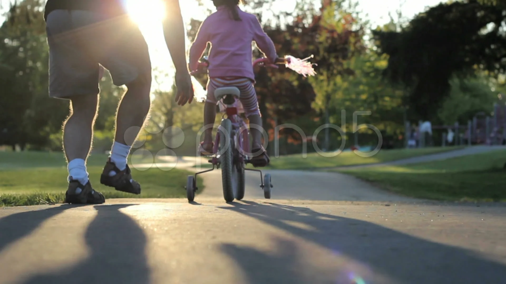 Excited Father Helps Daughter Ride Her New Bike Up Hill