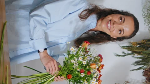 Excited florist make bouquet composition in plant shop vertically oriented. Stock Footage 254597130