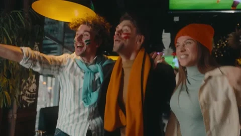 Excited friends crazy screaming supporting soccer team watching match at sports Stock Footage 274049437