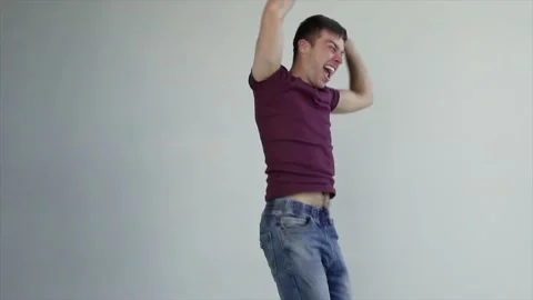 Excited guy student winner jumping and dancing feel amazed overjoyed Stock Footage 208372187