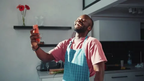 Excited handsome black man using smartphone for video call, chatting online with Stock Footage 131670010