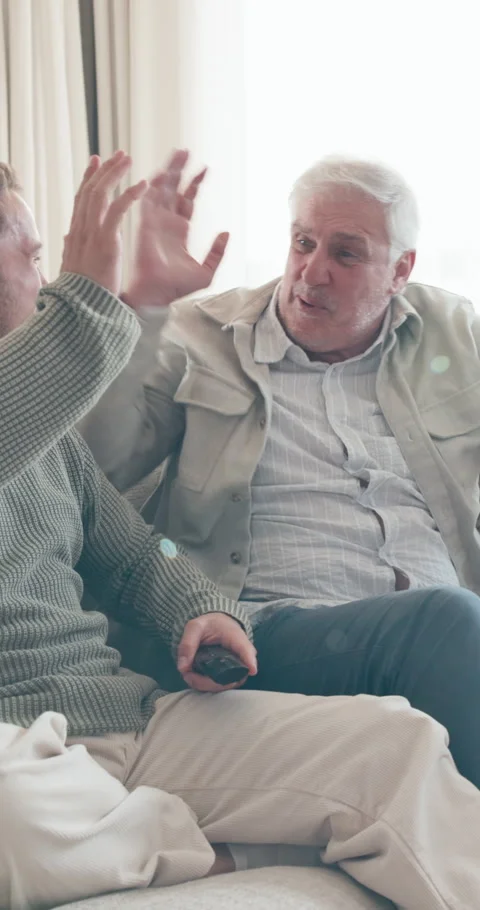 Excited, high five and senior man with son watching tv with remote control Stock Footage 341504841