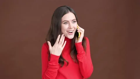 Excited lady answer call gadget fist up win isolated brown color background Stock Footage 189367177