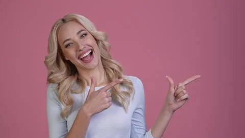 Excited lady point hand empty space ads isolated pastel color background Stock Footage 167544142