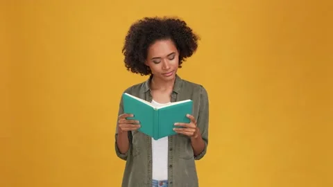 Excited lady read library paper book isolated mustard color background Stock Footage 166162265