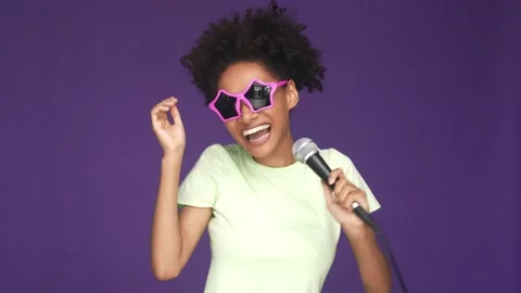 Excited lady sing mic hip hop dance isolated purple color background Stock Footage 165879412