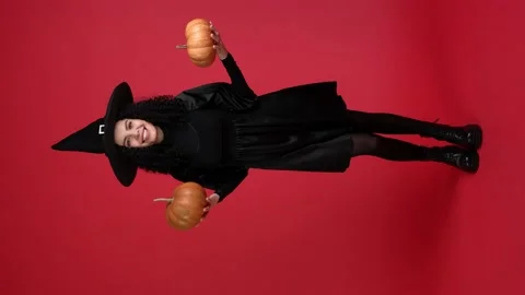 Excited lady warlock hold two gourd ripe prepare halloween occasion decor Stock Footage 217685127