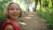Excited Little Girl Smiles And Runs Up Nature Trail Toward Her Family Stock Footage