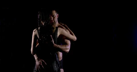 Excited lovers are hugging under rain in dark street, man is stroking body of Stock Footage 113405599