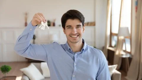Excited male client of realestate agency posing in new flat Stock Photos