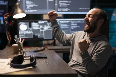 Excited Male Programmer Achieves Coding Breakthrough at Work Stock-Fotos