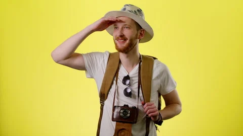 Excited Man With Backpack, Hat And Camera Happy Tourist Looks Around And Admires Stock Footage 170183632
