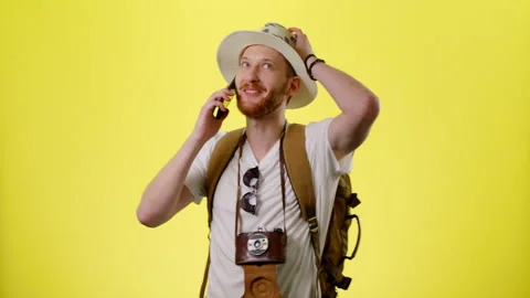 Excited Man With Backpack, Hat And Camera Tourist Admires Talking By Smartphone Stock Footage 170184136