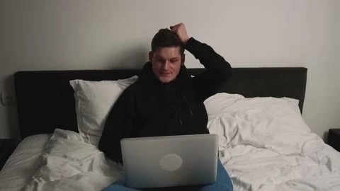 Excited man checking email reading great news on laptop in bedroom. Amazed male Stock Footage 148385940