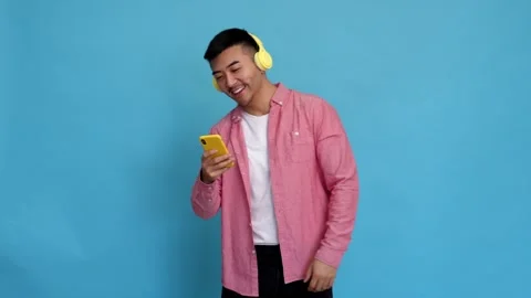 Excited man dancing while using mobile phone. Stock Footage 244401722