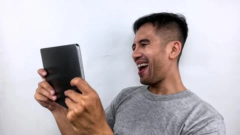 Excited Man Laughing While Using Tablet. Stock Footage 315229522