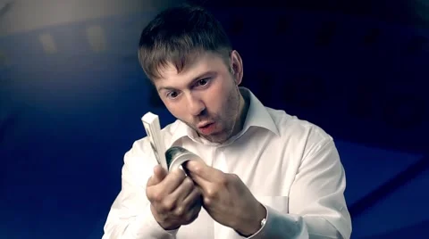 Excited man looking through his roll of bills in surprise Stock-Footage 68566105