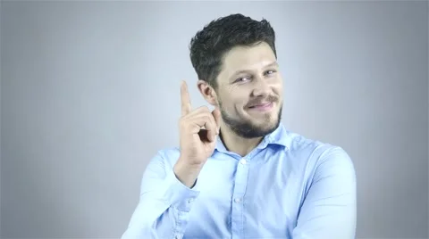 Excited man pointing a great idea - isolated over a gray background Stock Footage 41795415