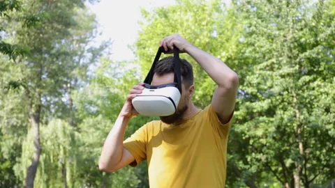 Excited man in vr headset gesturing in park Stock-Footage 136115314