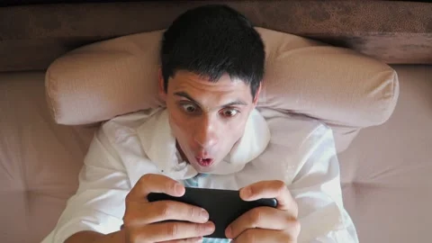 Excited man winner holding using smartphone feeling overjoyed with mobile online Stock Footage 134539521