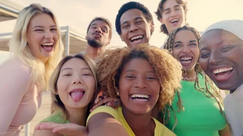 Excited multi-ethnic friends taking selfie outdoors during sunset Stock Footage 265015705