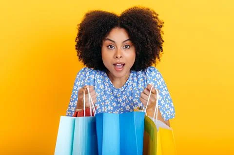 Excited positive gorgeous curly haired latino or african american fashion woman Stock Photos