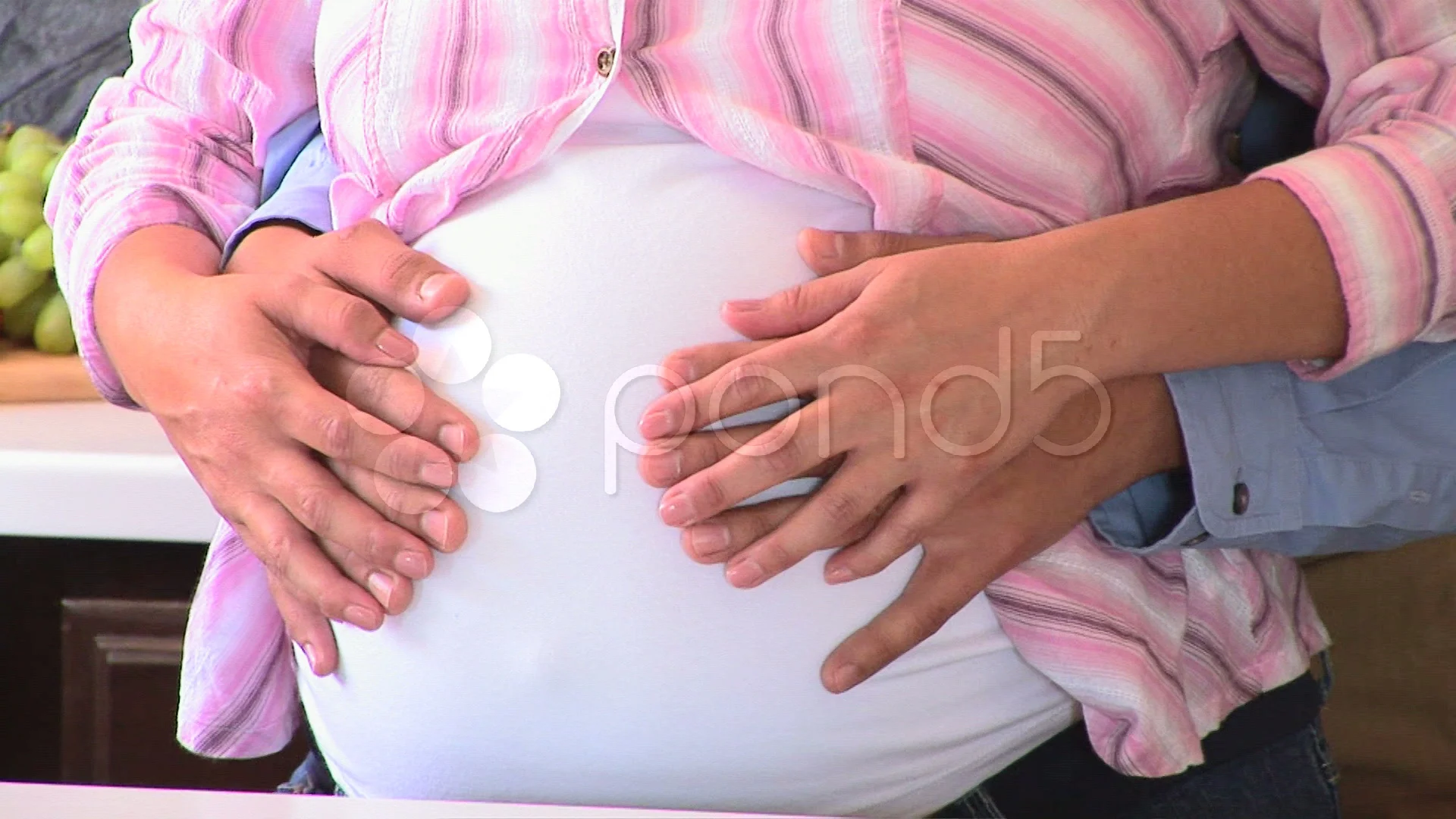 Expectant couple sharing a tender moment, with hands on the belly Stock  Photo by Prostock-studio