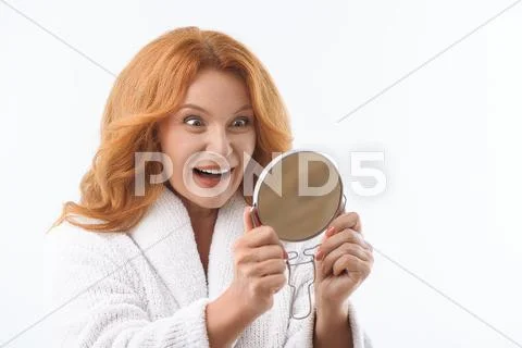 Excited senior lady is satisfied with her appearance Stock Photos