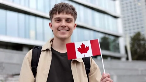 Excited student with a small Canada flag enjoy exchange study, Canada day. Stock Footage 317083091