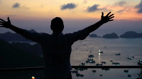 Excited successful man at Ha Long Bay in Vietnam, slow motion Stock Footage 163344458