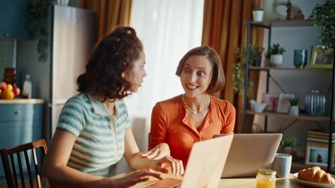 Excited two winners looking laptop receiving great news in home kitchen closeup. Stock Footage 333791218