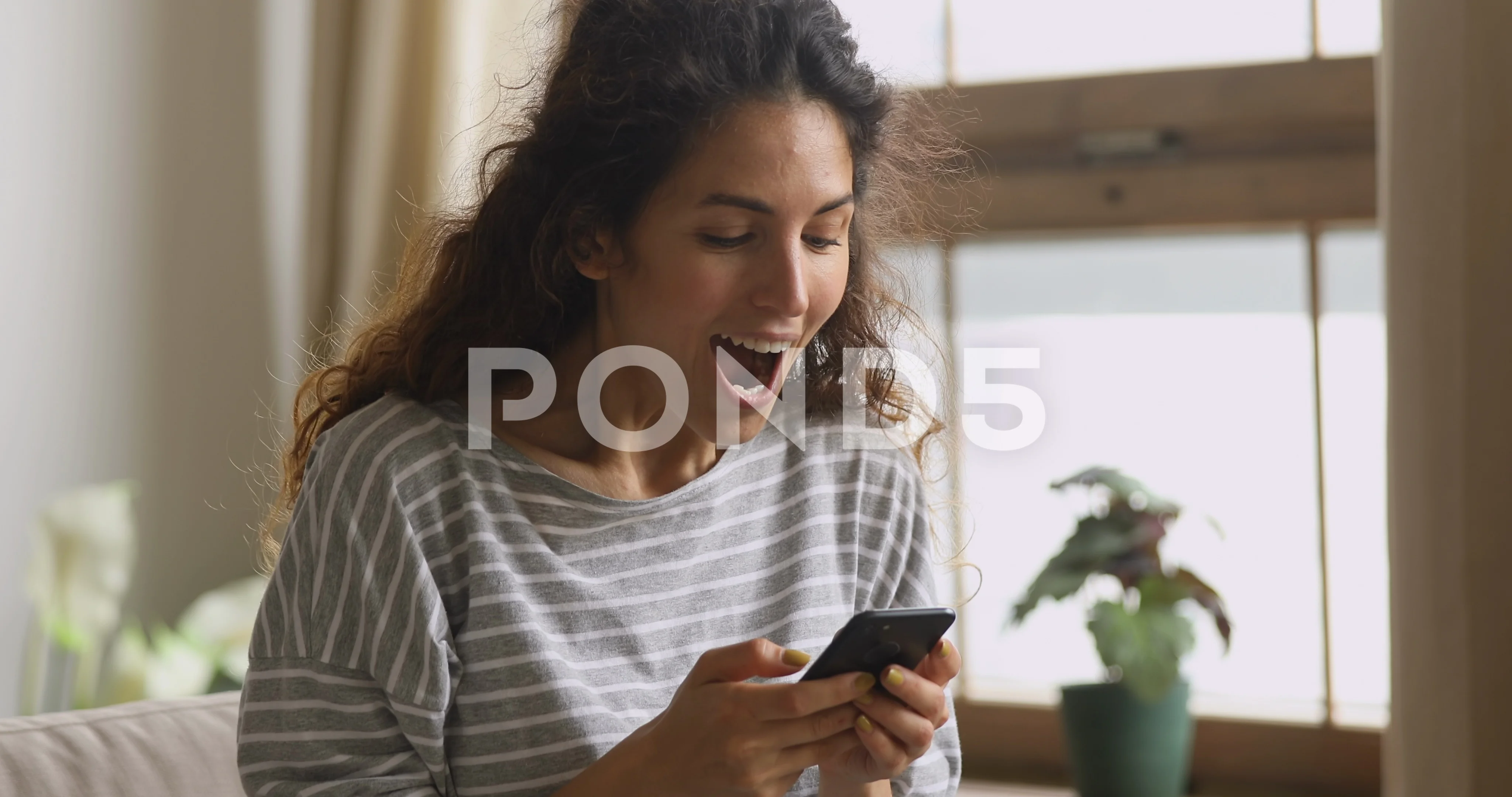 Happy female hold phone chat in social network read good news, shopping via  online store app at home Stock Photo by StudioVK