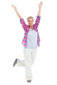 Excited woman standing with hands and foot up in air Stock Photos