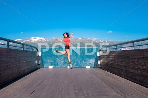 Excited woman tourist at Stegastein Viewpoint Stock Photos