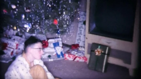 Excited Young Boy Sitting In Front Of Christmas Tree-1963 Vintage 8mm film Stock Footage 75767940