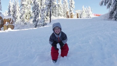Excited Young Boy Throws Snowball - 4k - Slow Motion Video stock 77880858