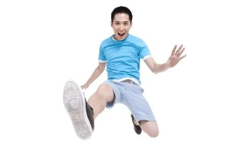 Excited young Chinese man jumping in mid air Beijing China Copyright: xLia... Stock Photos