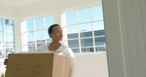 Excited young couple moving boxes into their new home on moving day. Stock Footage 88373636