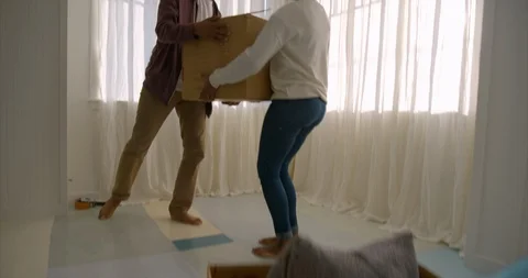 Excited young couple moving boxes on moving day. 스톡 동영상 88374022