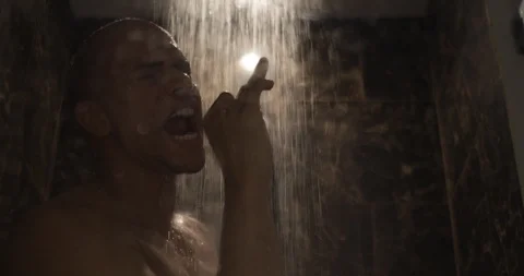 Excited young man dancing and singing in the shower Stock Footage 99270731