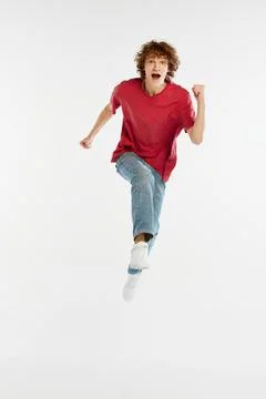 Excited young man running isolated over white background. Sport, dance, fitness Stock Photos