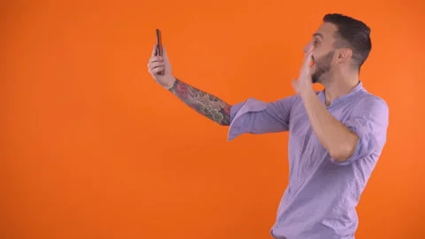 Excited young man video calling, smiling and waving with hand. Saying I love you Stock Footage 138505358
