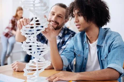Excited young scientists discovering the structure of human genome Stock Photos