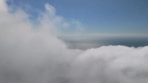 Exciting 4K drone clip diving directly through a thick cloud layer over the Vídeos de archivo 332811935